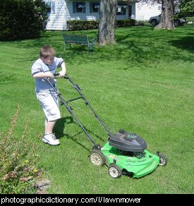 Photo of a boy mowing a lawn